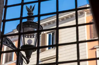 a view of a street light through a window at Palazzo Borghese, a Burghesius home in Rome