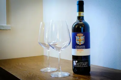 a bottle of wine sitting next to two wine glasses at Restart Accommodations Colonna e Ludovisi in Rome