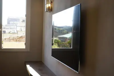 a mirror on a wall next to a window at Restart Accommodations Colonna e Ludovisi in Rome
