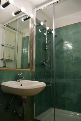 a bathroom with a sink and a glass shower at Appartamento a Piazza Navona in Rome