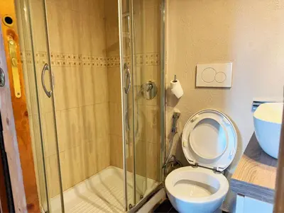 a bathroom with a toilet and a glass shower at Nice 2 CU in Rome