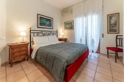 a bedroom with a bed and a table and a chair at Marta Suite - Metro Malatesta & Wi-Fi in Rome