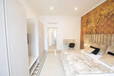a bedroom with a large bed with a wooden wall at Splendor Eternal 3 BR Apartment in the City Center in Rome