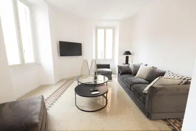 a living room with a couch and a table at Splendor Eternal 3 BR Apartment in the City Center in Rome