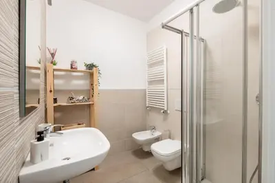 a bathroom with a white sink and a toilet at Pigneto Terrace - Residenze Romanae in Rome