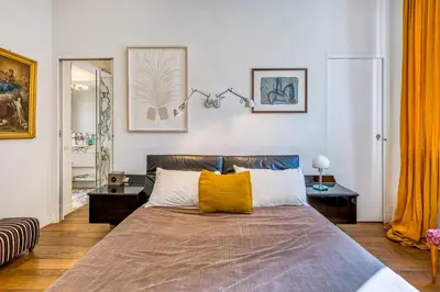 a bedroom with a large bed with orange curtains at Skylife Eco-Luxe Trastevere Haven in Rome