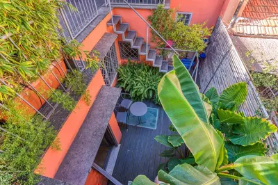 an overhead view of an orange building with stairs and plants at Skylife Eco-Luxe Trastevere Haven in Rome