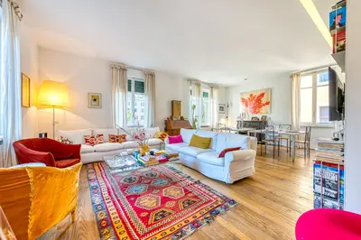 a living room with white couches and a rug at Skylife Eco-Luxe Trastevere Haven in Rome