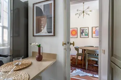 a kitchen with a table and a dining room at iFlat Monti Life with Elegance, Comfort and Beauty in Rome