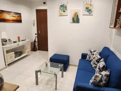 a living room with a blue couch and a table at La casetta di Marco in Rome