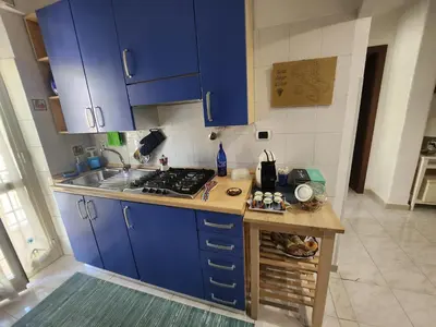 a kitchen with blue cabinets and a counter top at La casetta di Marco in Rome