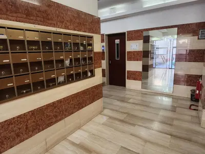 a hallway with lockers and a door in a building at La casetta di Marco in Rome