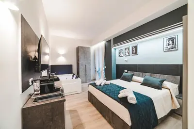 a bedroom with a large bed and a bathroom at Monteverde Vatican in Rome