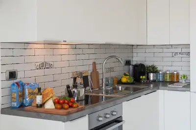 a kitchen with a sink and a counter with fruits and vegetables at Boutique Domus Trastevere Penthouse in Rome