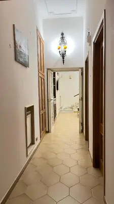 a hallway with a tile floor and a chandelier at Pantheon Luxury Noble Apartment in Rome