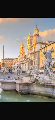 a fountain with statues in front of a building at Pantheon Luxury Noble Apartment in Rome