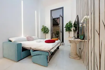a bedroom with a bed with pillows and a mirror at Principe Amedeo piano terra in Rome