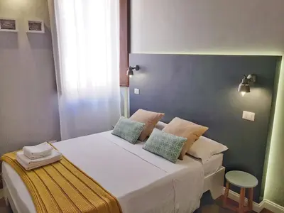 a bedroom with a bed with two pillows on it at RomExperience Borgo Pio in Rome