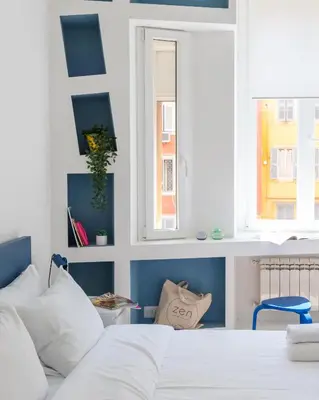 a bedroom with a white bed and a window at Quiet retreat in Trastevere - ZENO 45 in Rome