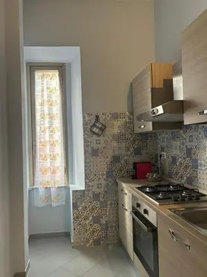a kitchen with a stove and a window at A Casa di Mario al Pigneto in Rome