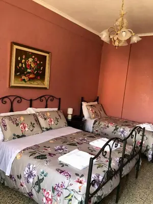 a dining room with a wooden table and chairs at MyHomeinRome - Zona Re di Roma in Rome