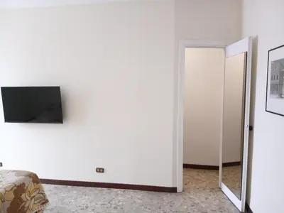 a white room with a television and a mirror at WelcHomeRome in Rome
