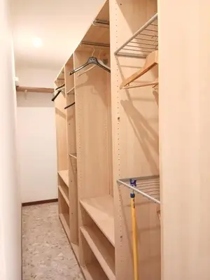 a closet with wooden shelves and a baseball bat at WelcHomeRome in Rome
