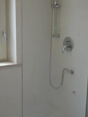 a shower with a shower head in a bathroom at Penthouse in Trastevere - Entire House in Rome