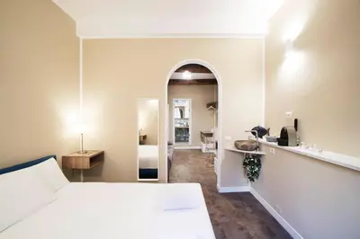 a hotel room with a bed and a mirror at DolceVite - Piazza Di Spagna in Rome
