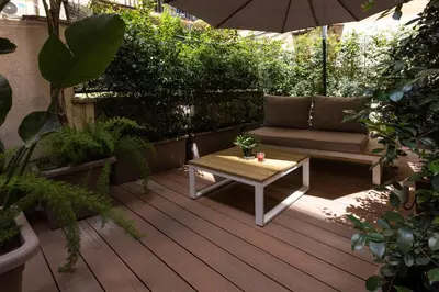 a patio with a couch and a table on a deck at DolceVite - Piazza Di Spagna in Rome