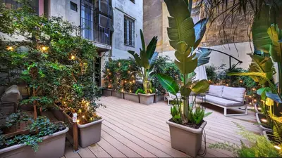 a patio with plants and a couch and lights at DolceVite - Piazza Di Spagna in Rome