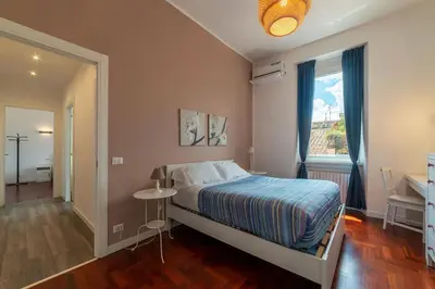 a small bedroom with a bed and a window at Casa Matilde - WelcomeToRhome in Rome