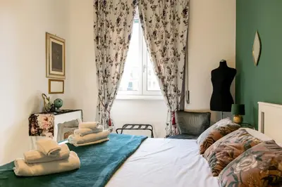 a bedroom with towels on a bed with a window at Casa Nanna Chic in Vatican in Rome