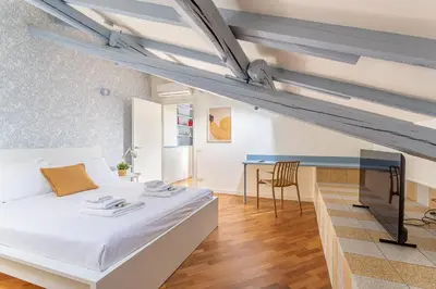 a bedroom with a white bed and a desk at iFlat Vatican New & Comfy Sunlit Apartment in Rome