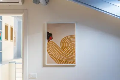a painting on a wall in a room at iFlat Vatican New & Comfy Sunlit Apartment in Rome