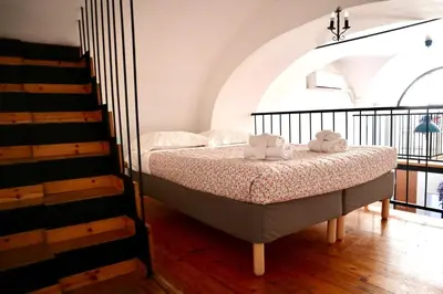 a bedroom with a bed with two towels on it at Loft in Rhome in Rome