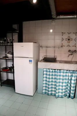 a kitchen with a white refrigerator and a counter at Loft in Rhome in Rome