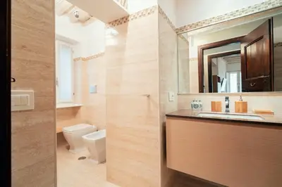 a bathroom with a sink and a toilet at Majorelle comfy apartment in Rome