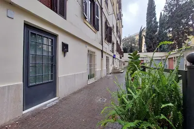 an empty alley with a building and a door at Charm Apartment San Giovanni in Rome