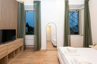 a bedroom with a large mirror and a television at Casa Gazometro in Rome