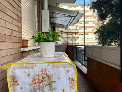 a table on a balcony with a plant on it at Mary's Apartment - House for 4 people - Close to the Vatican in Rome