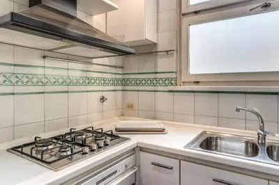 a kitchen with a stove and a sink at Zeus House in Rome