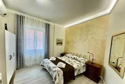 a bedroom with a bed and a window at Elegant Home in Rome Appio, Wi-Fi, Subway in Rome