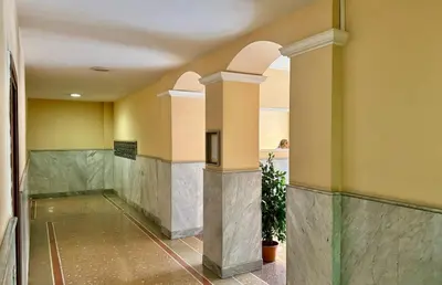 a hallway of a building with columns at Elegant Home in Rome Appio, Wi-Fi, Subway in Rome