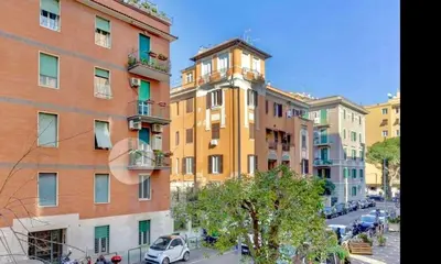 a building with a clock tower in a city at Elegant Home in Rome Appio, Wi-Fi, Subway in Rome