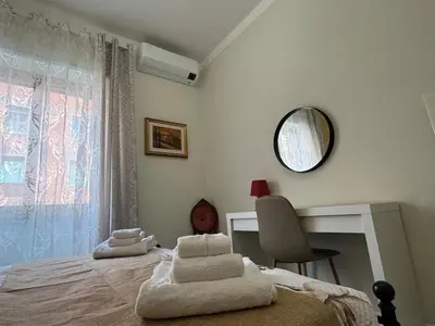a bedroom with a bed and a desk and a mirror at Elegant Home in Rome Appio, Wi-Fi, Subway in Rome