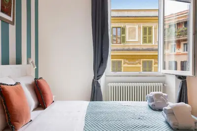 a bedroom with a bed and a window at Dandolo Top Floor Trastevere in Rome