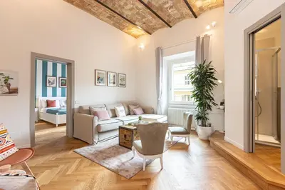 a living room with a couch and a table at Dandolo Top Floor Trastevere in Rome