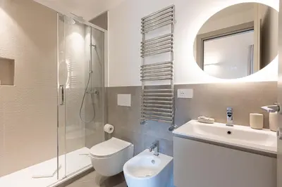 a bathroom with a sink toilet and a mirror at Dandolo Top Floor Trastevere in Rome