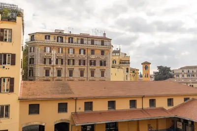 an old building with a roof in a city at Domus Merulana 209 Colosseum Apt in Rome